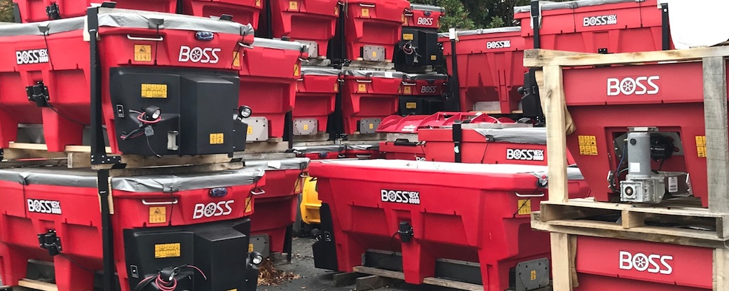 Many Boss salt spreaders stacked at our store
